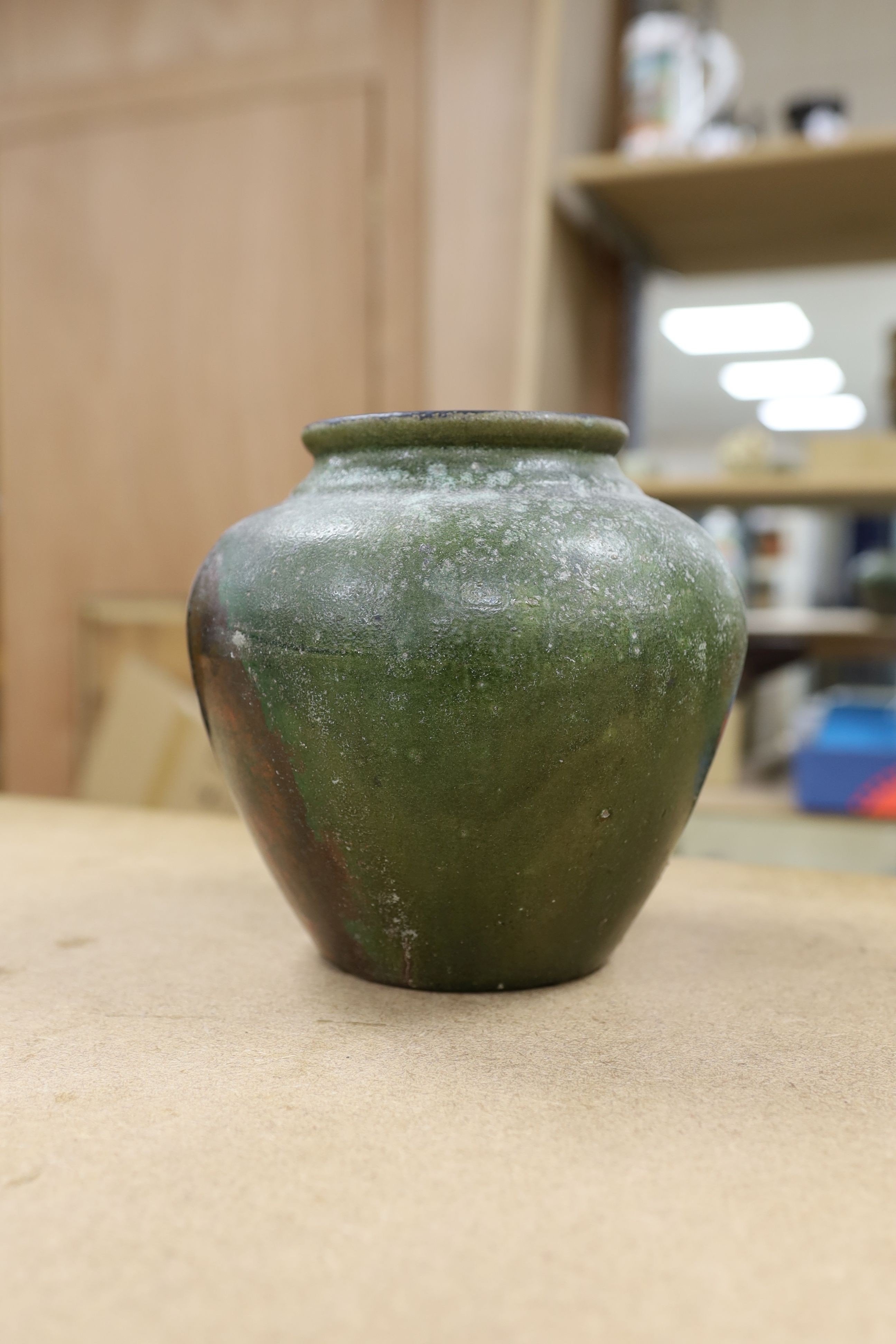 A copper lustre and green glazed pottery jar, 17.5cm high